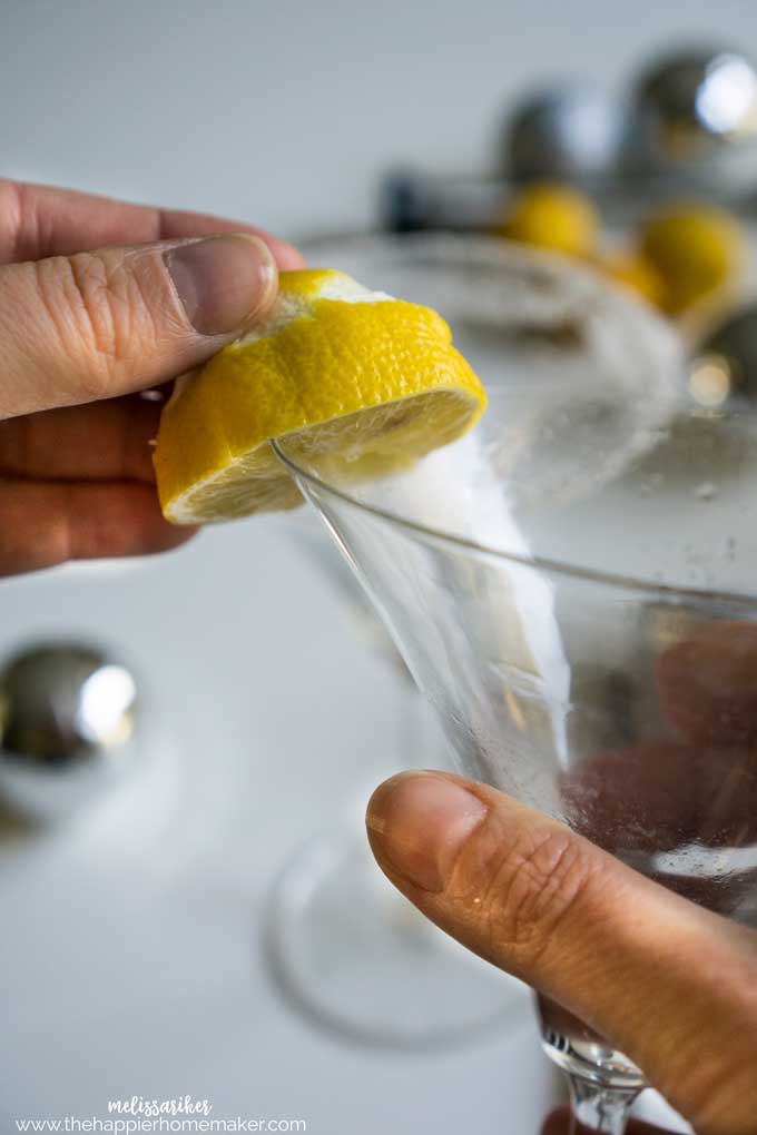 A Lemon drop Martini having the rim coated with lemon juice from a lemon