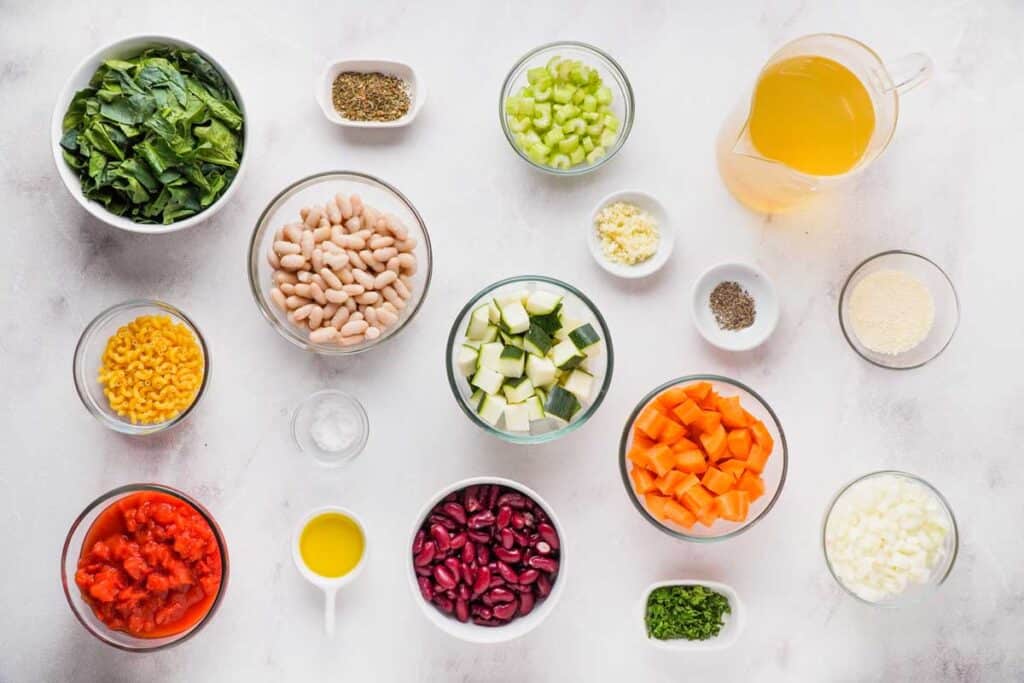 minestrone soup ingredients on marble countertop