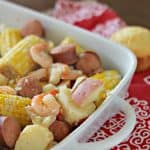 A close up of a lowcountry boil on a red and white napkin
