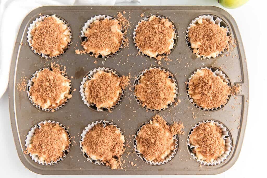 cinnamon apple muffins in tin before baking