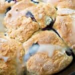 close up photo of blueberry buttermilk biscuits with lemon glaze