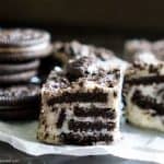 A close up of a piece of three ingredient Oreo cookie with chocolate fudge