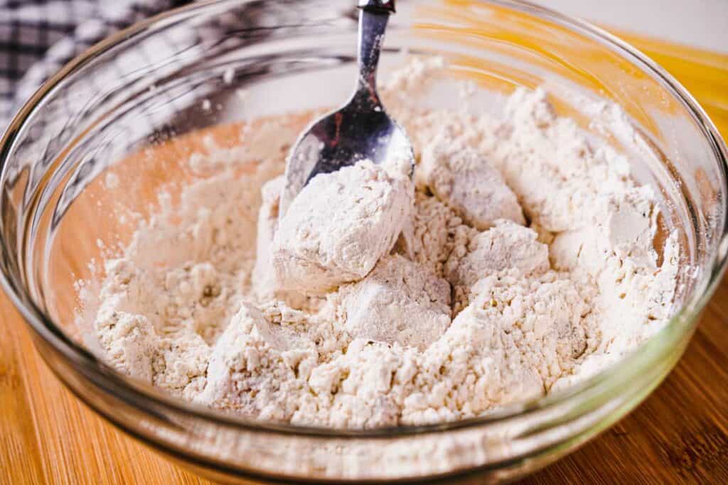 dredging chicken pieces in flour