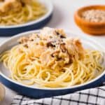 chicken mushroom parmesan pasta on white and blue plate
