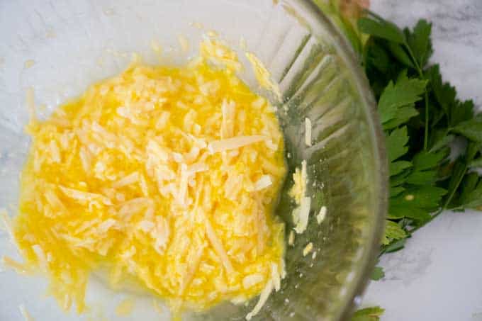 cheese and egg mixed in glass bowl