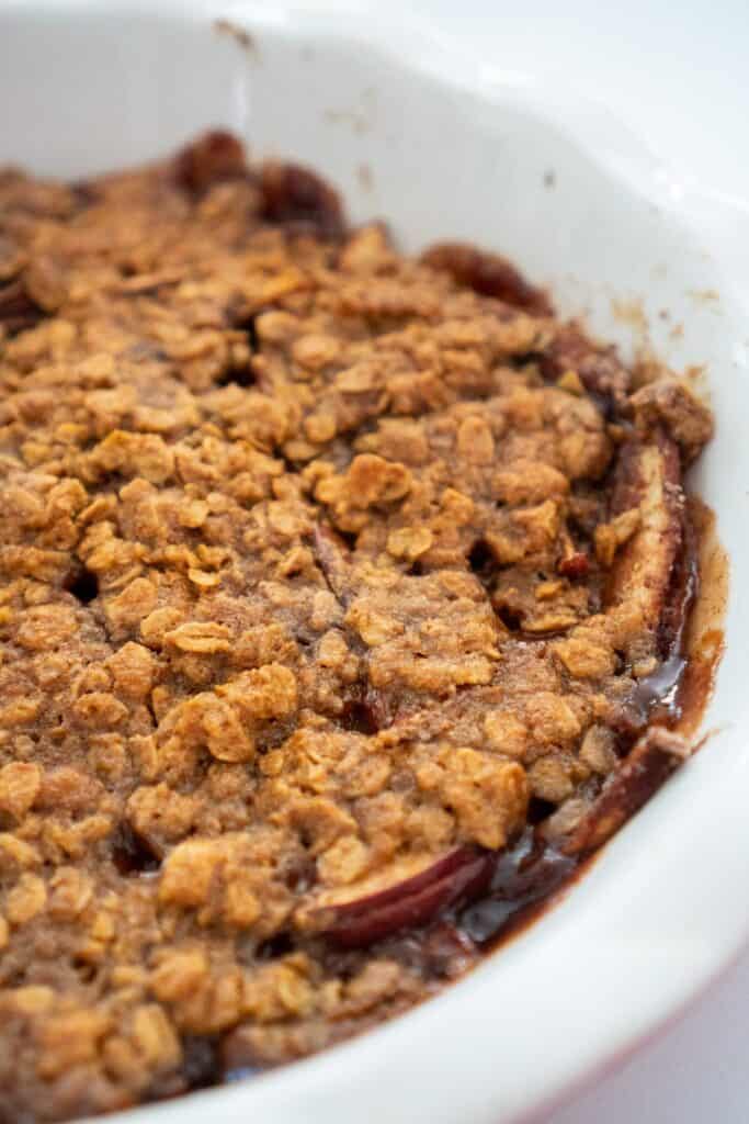 close up of peanut butter apple crisp in white pan