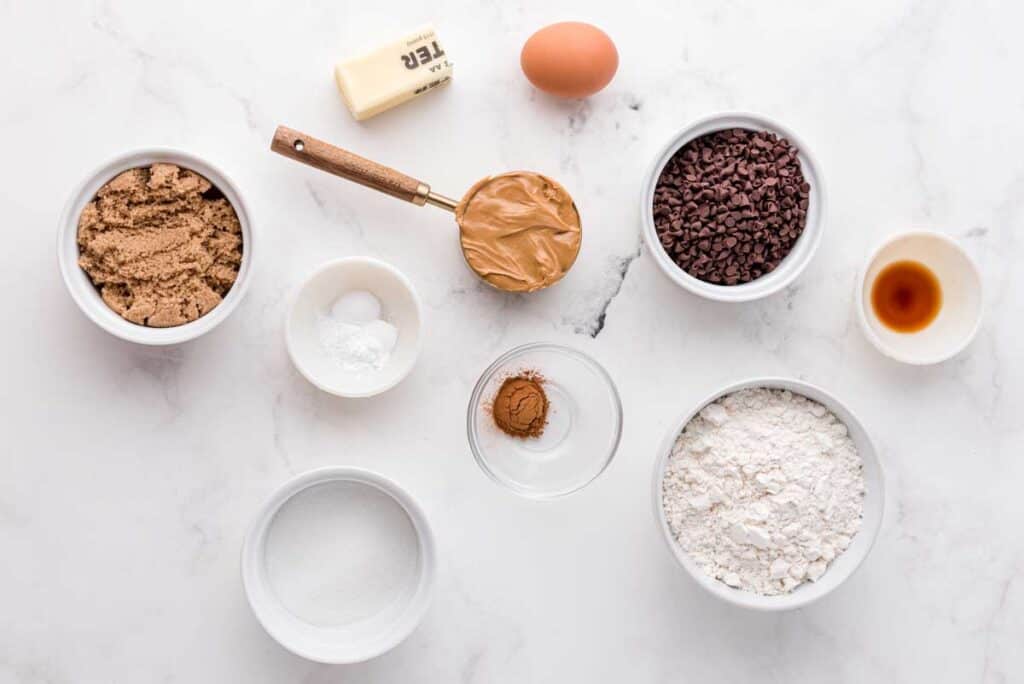 peanut butter chocolate chip cookie ingredients on marble countertop