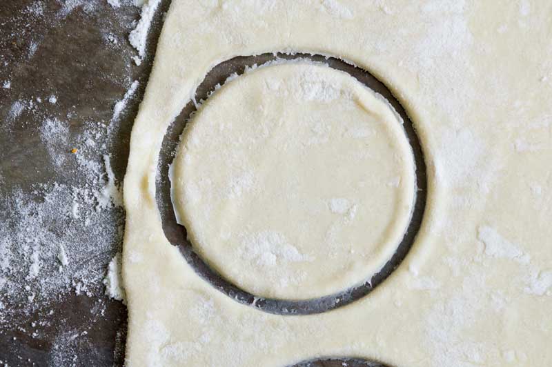 puff pastry dough cut into a circle with biscuit cutter
