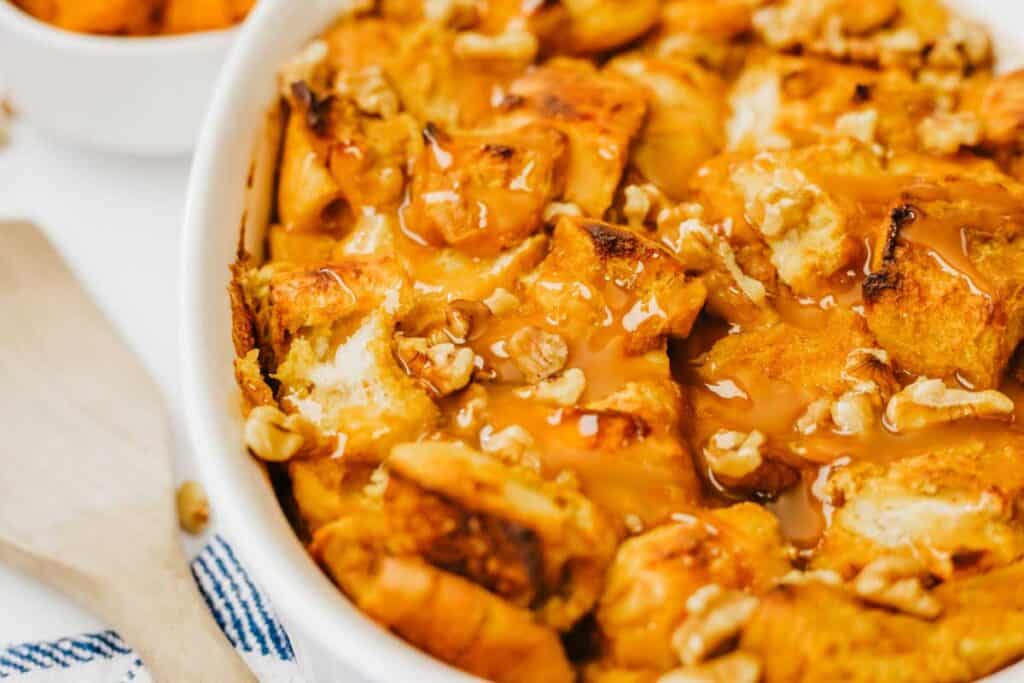 close up of pumpkin bread pudding in white dish