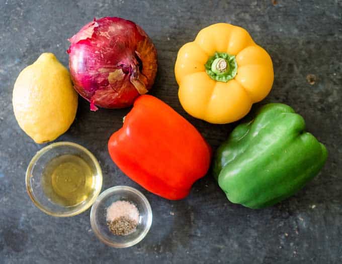 red, yellow, and green bell peppers with roasting ingredients