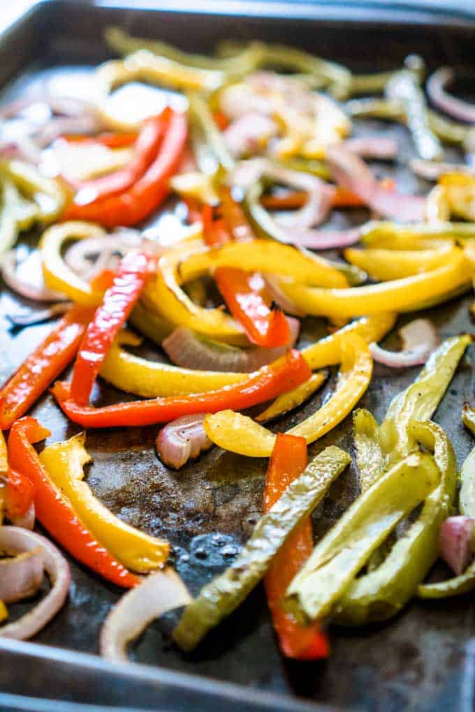 roasted bell peppers and onions on baking sheet