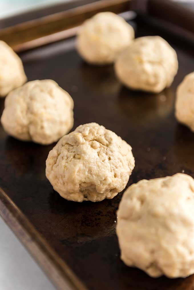 balls of biscuit dough on a baking sheet