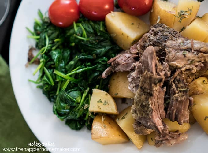 Greek leg of lamb with potatoes, greens and cherry tomatoes 