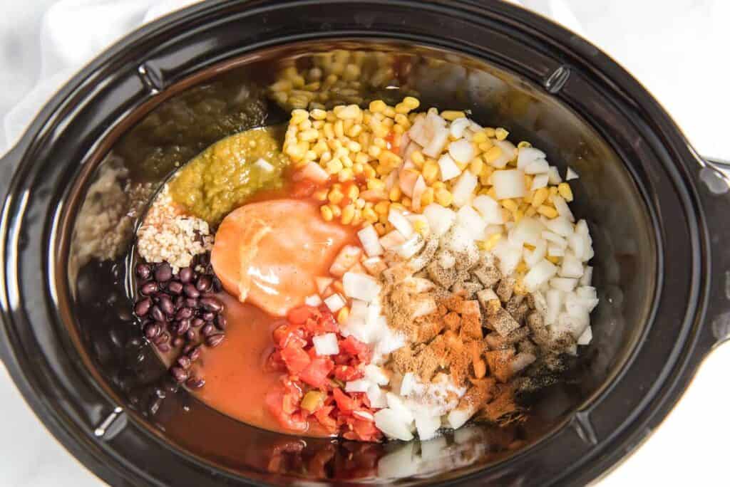 overhead view of chicken tortilla soup ingredients in slow cooker