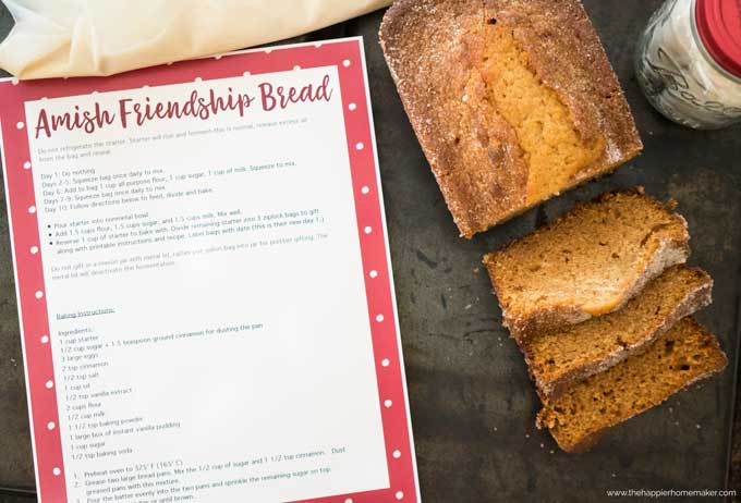 A loaf of sliced friendship bread sitting on a table with the printed instructions next to it
