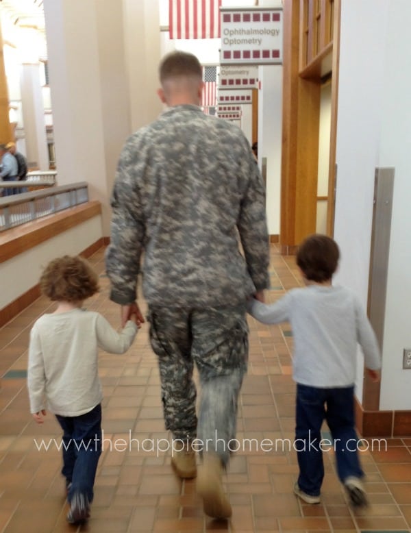 military dad walking with two sons from behind
