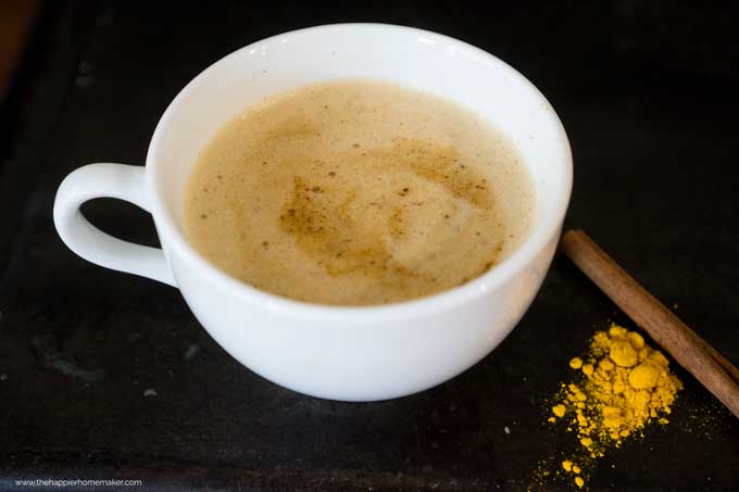 side view of a turmeric latte in a white mug